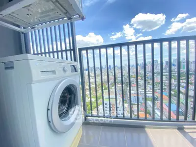 Stunning high-rise balcony with cityscape view and modern washing machine.