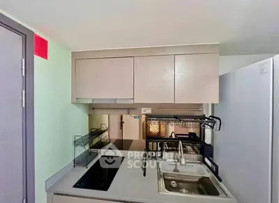 Modern compact kitchen with sleek cabinetry and built-in appliances, perfect for urban living.
