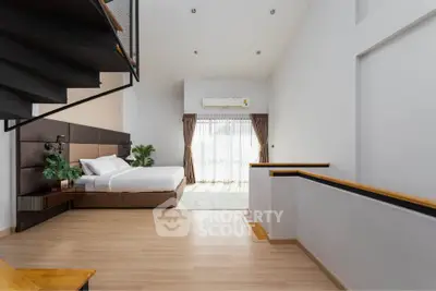 Spacious modern bedroom with high ceiling and natural light