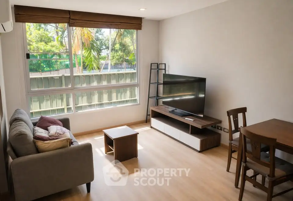 Bright and cozy living room with modern furniture and large window view.