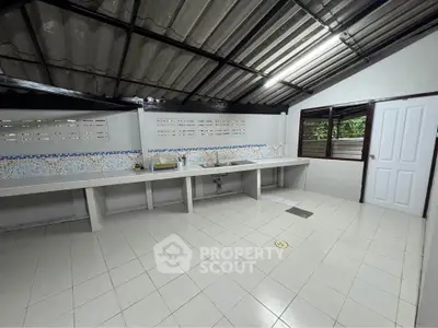 Spacious tiled kitchen with open layout and modern design
