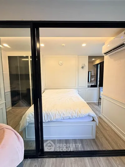 Modern bedroom with glass partition and cozy decor in a stylish apartment