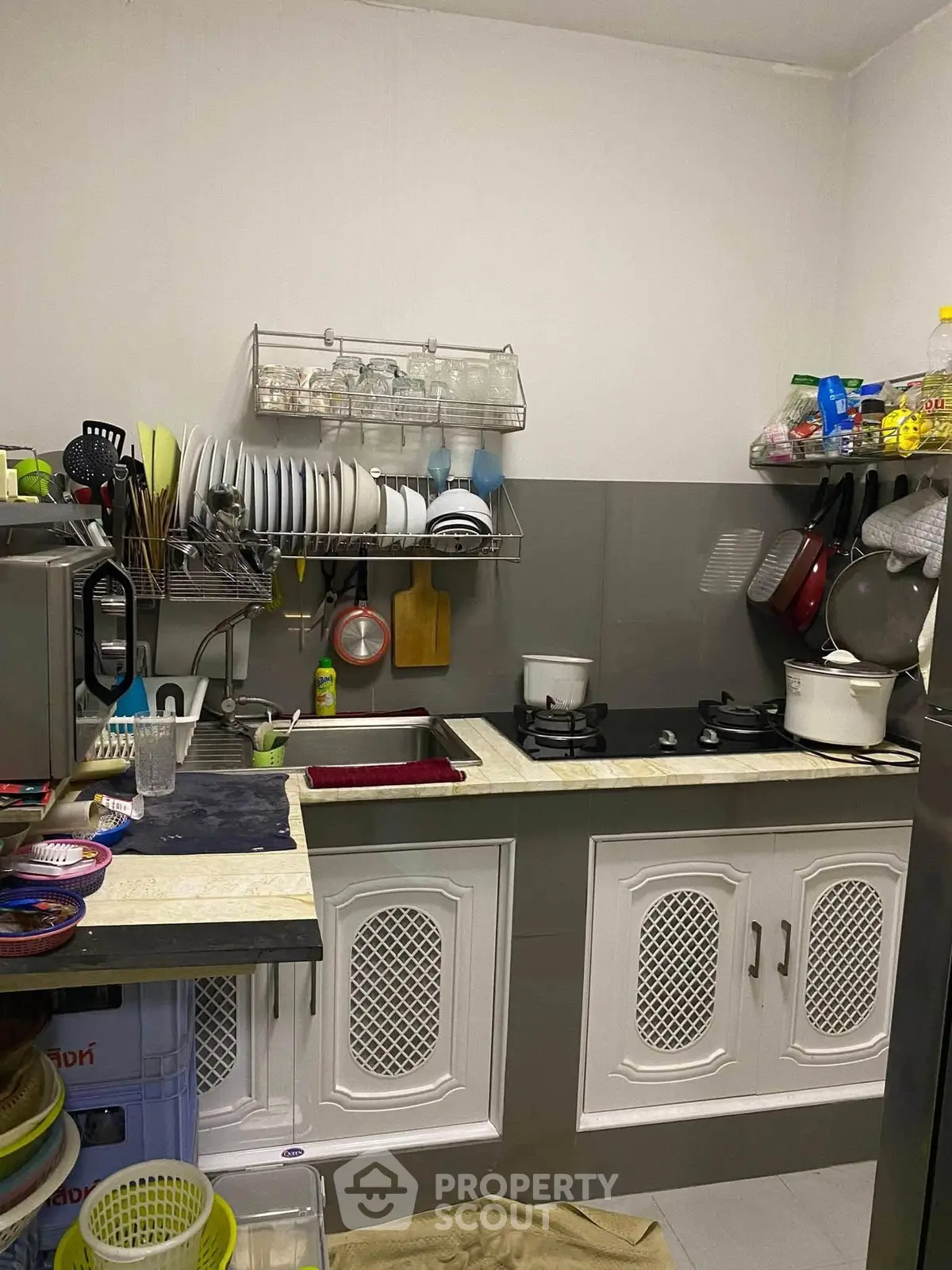 Cozy kitchen with gas stove and ample storage space, perfect for culinary enthusiasts.