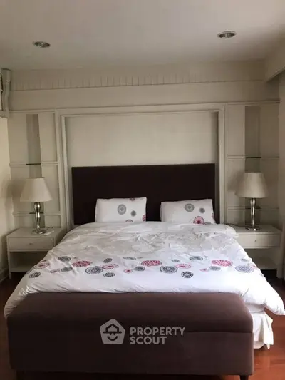 Elegant bedroom with stylish decor and cozy bedding in a modern apartment.