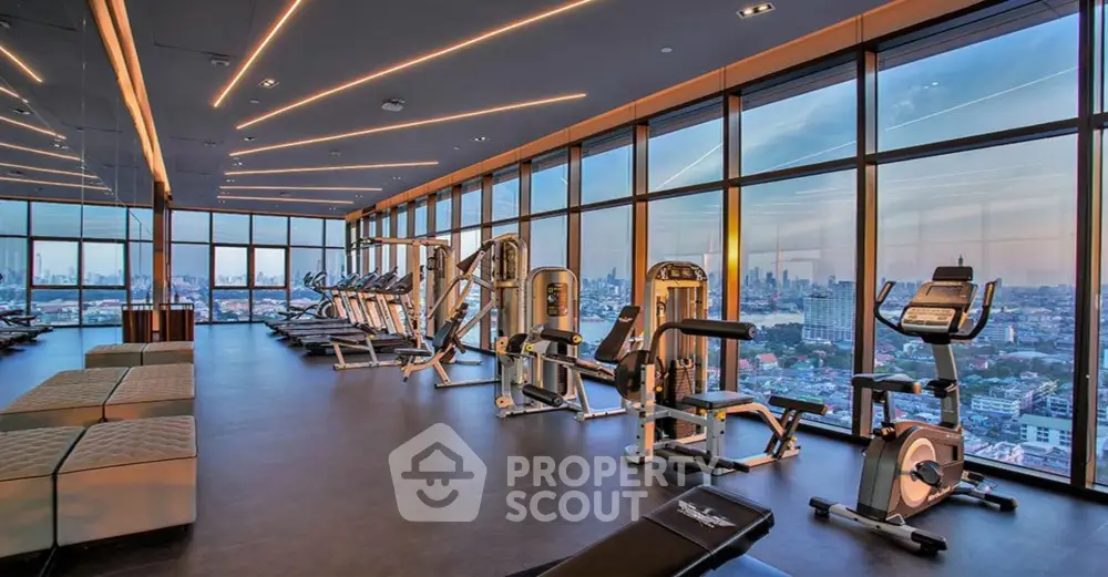 Luxurious high-rise gym with panoramic city views and modern fitness equipment.