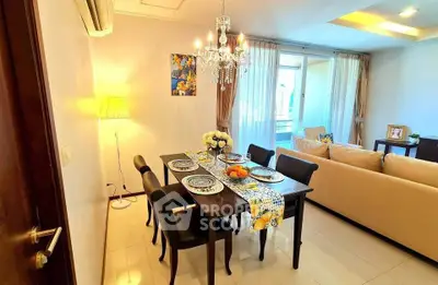 Elegant living room with dining area, chandelier, and balcony access in modern apartment.