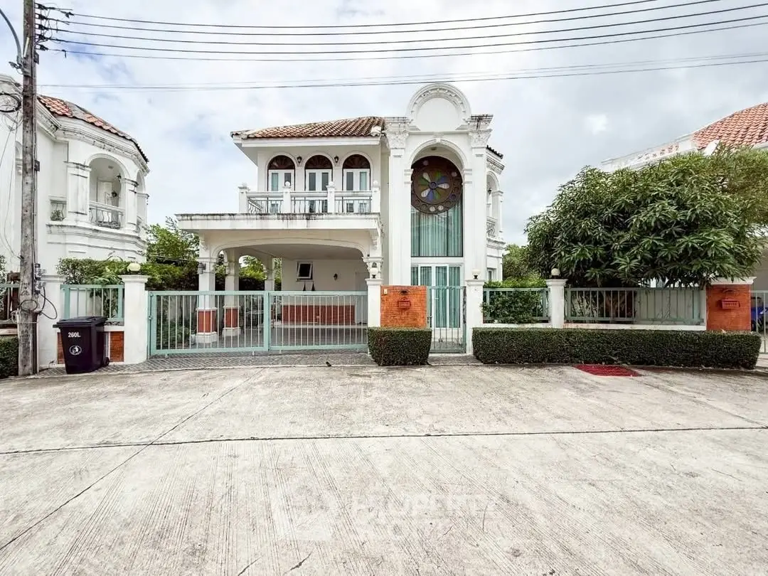 Elegant two-story house with classic architecture and lush greenery