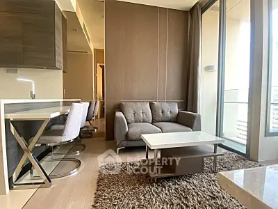 Modern living room with stylish furniture and large balcony view