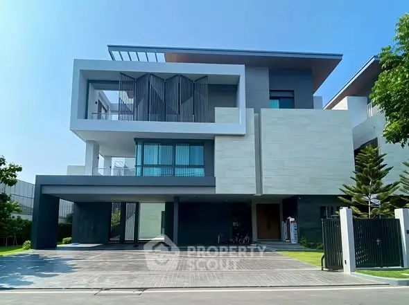 Modern luxury home with sleek architectural design and spacious driveway in a serene neighborhood.