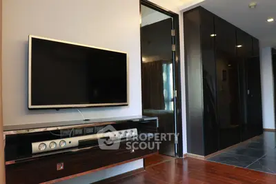 Modern living room with sleek TV setup and stylish wooden flooring