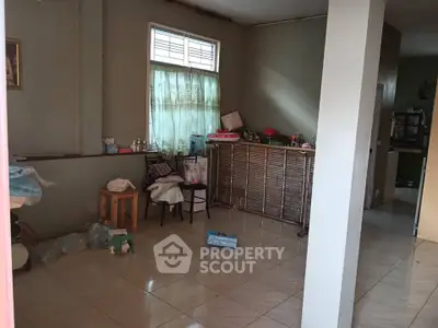 Spacious living area with tiled flooring and natural light, ideal for customization.