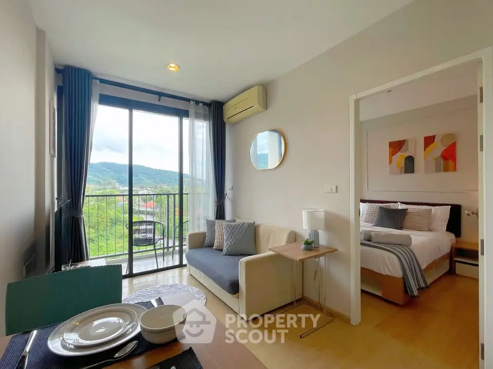 Modern studio apartment with balcony and scenic view, featuring cozy living area and stylish decor.