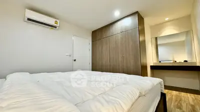 Cozy bedroom with modern wardrobe and air conditioning, perfect for relaxation.