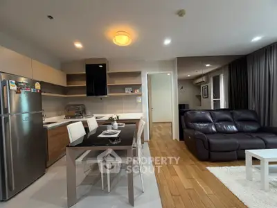 Modern open-plan kitchen and living room with sleek design and cozy ambiance