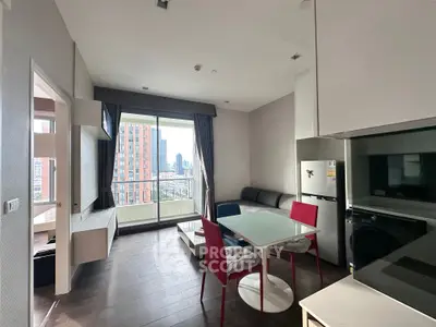 Modern apartment living room with city view, featuring sleek furniture and large windows for natural light.