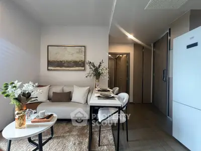 Modern living room with elegant decor and dining area in a cozy apartment setting.