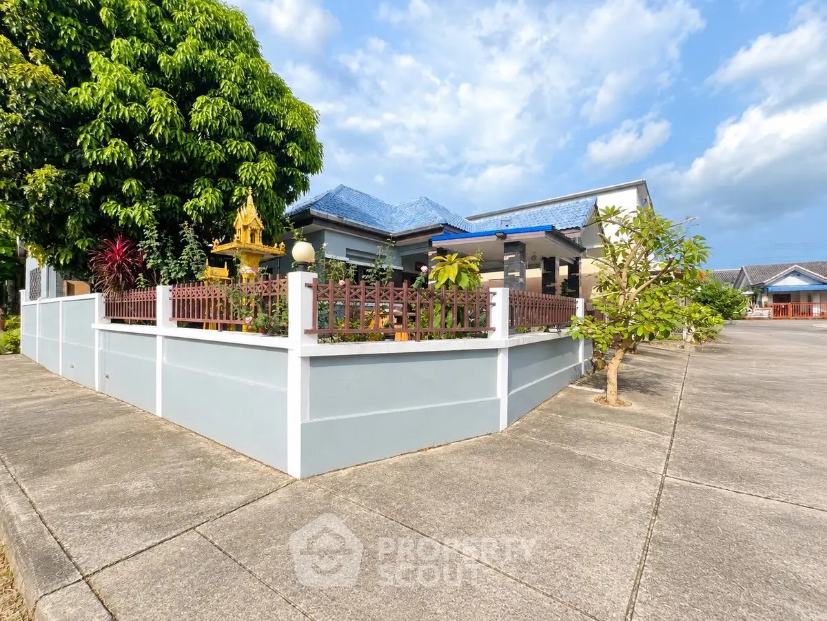 Charming corner house with lush garden and spacious driveway in a serene neighborhood.