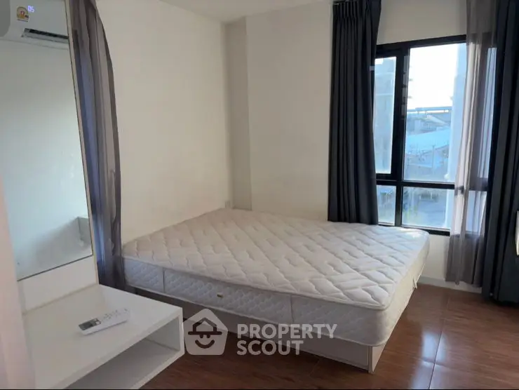 Modern bedroom with slanted ceiling and large window