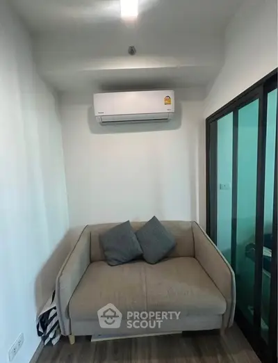 Cozy living room with modern air conditioning and stylish sofa, perfect for relaxation.