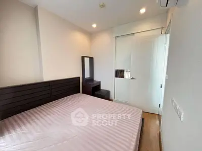 Modern bedroom with sleek furniture and ample natural light