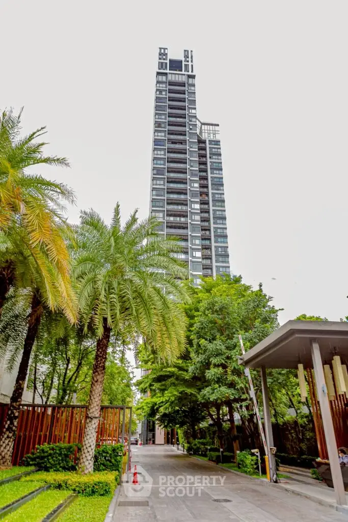 Stunning high-rise building surrounded by lush greenery and palm trees