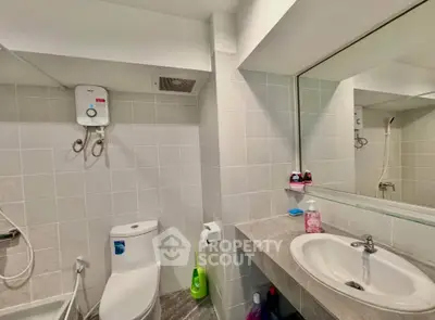 Modern bathroom with sleek fixtures and water heater, ideal for comfort and convenience.