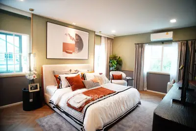 Luxurious bedroom with modern decor, large windows, and stylish furnishings, perfect for comfort and relaxation.