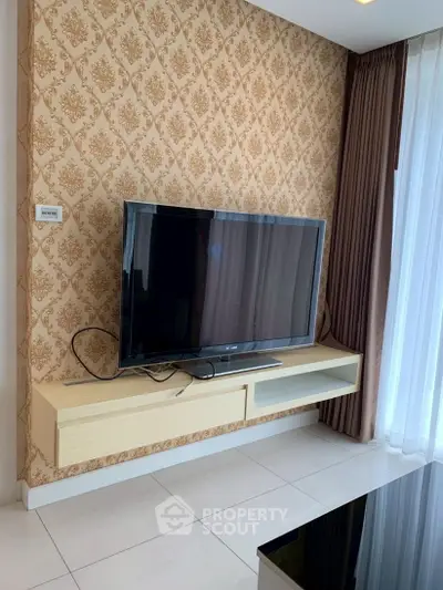 Modern living room with stylish wallpaper and mounted TV, perfect for cozy evenings.