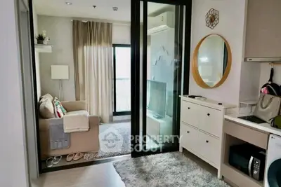 Modern living room with cozy sofa, TV, and stylish decor in a bright apartment.