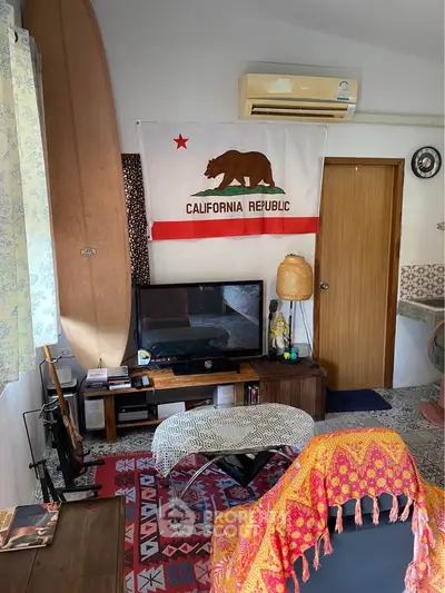 Cozy living room with surfboard decor, California Republic flag, and eclectic furnishings.