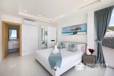 Modern bedroom with elegant decor and natural light, featuring a serene beach-themed artwork.