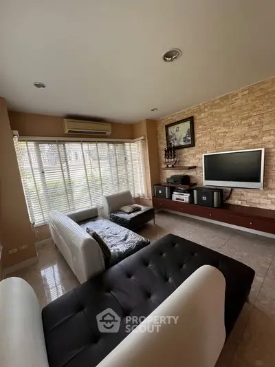 Spacious living room with modern decor and large windows for natural light.