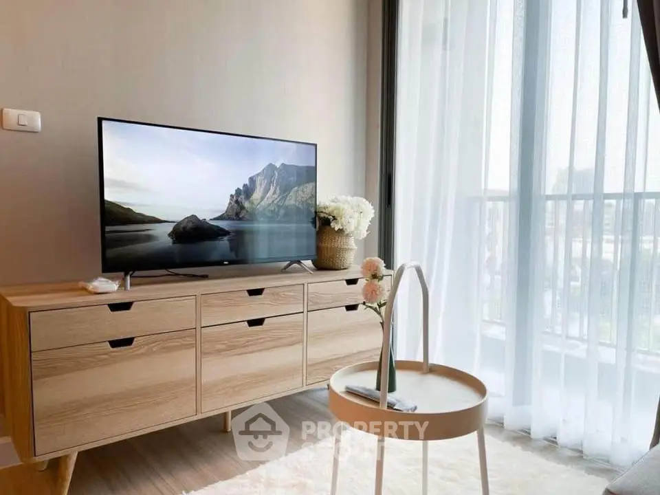 Modern living room with stylish TV stand and balcony view