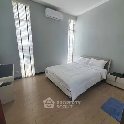 Spacious bedroom with modern decor and natural light