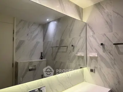 Luxurious marble bathroom with modern fixtures and ambient lighting