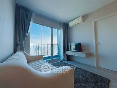 Modern living room with city view, featuring sleek sofa and wall-mounted TV, perfect for urban living.