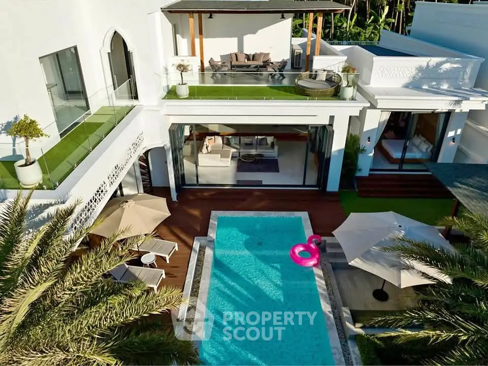 Luxurious modern villa with private pool, spacious terrace, and elegant outdoor seating area.