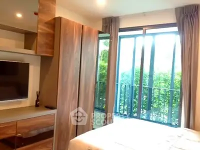 Cozy bedroom with large window and modern wooden furniture