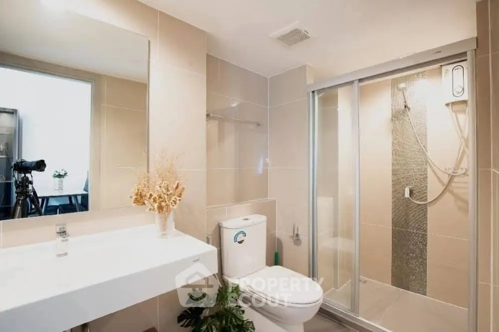 Modern bathroom with sleek shower and elegant fixtures in a stylish real estate property.