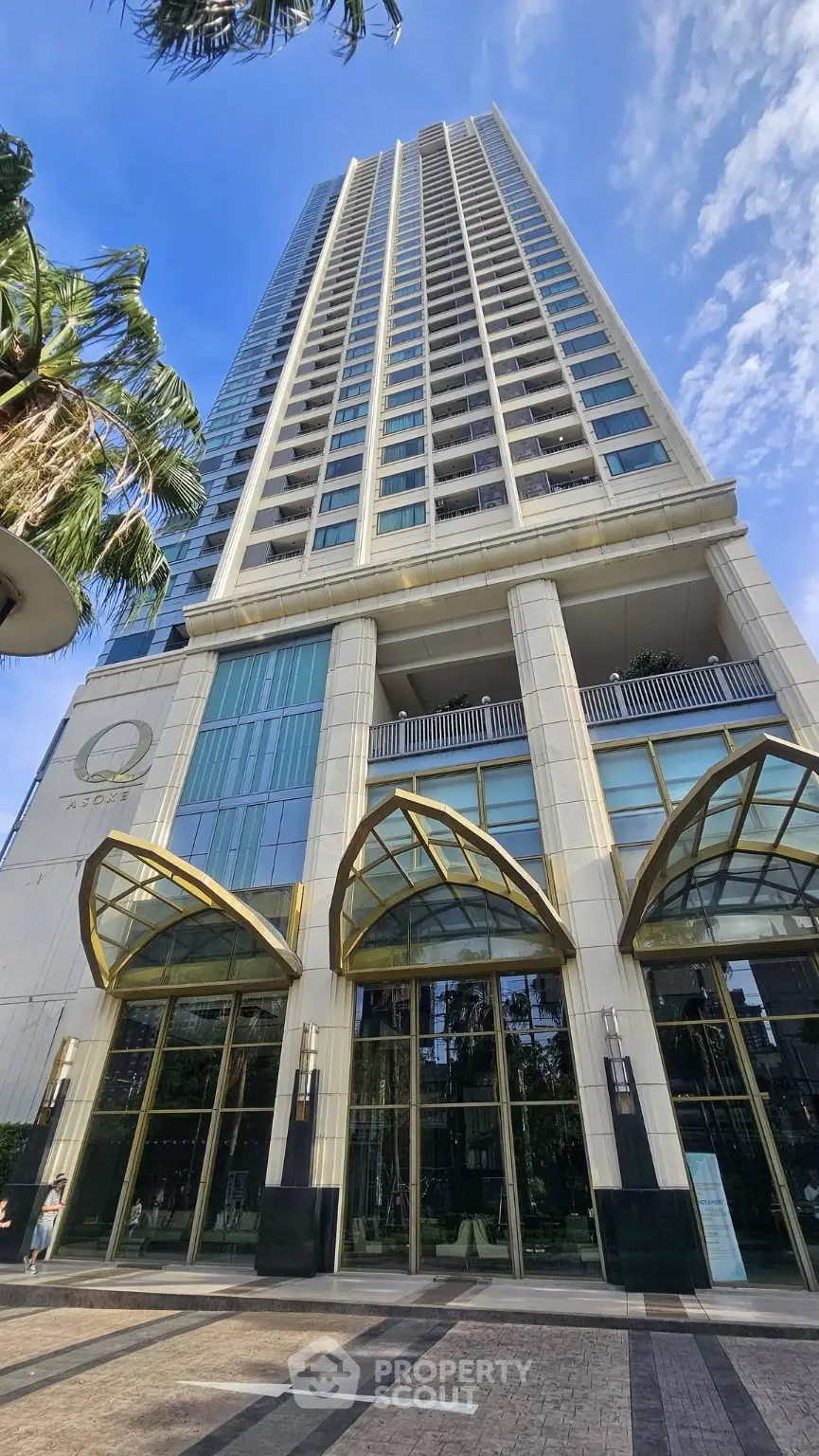 Stunning high-rise building exterior with modern architecture and lush surroundings.