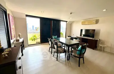Spacious living room with city view, elegant dining set, and modern decor in a high-rise apartment.