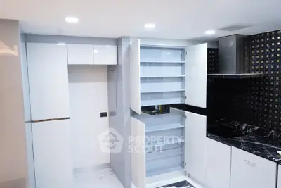 Modern kitchen with sleek cabinetry and black marble countertops