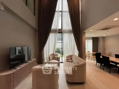 Luxurious modern living room with high ceilings and elegant furnishings