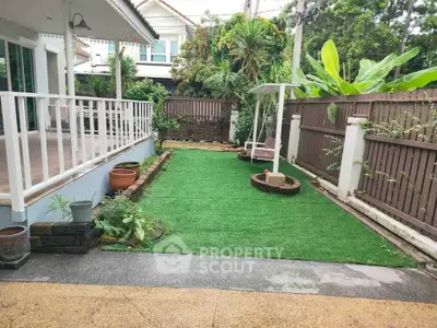 Charming garden with lush greenery and cozy swing in a serene residential setting.