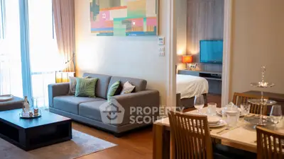 Modern open-plan living room with dining area and cozy bedroom in stylish apartment.