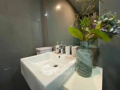 Modern bathroom with sleek sink and decorative vase