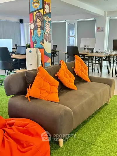 Modern office space with vibrant decor and comfortable seating area.