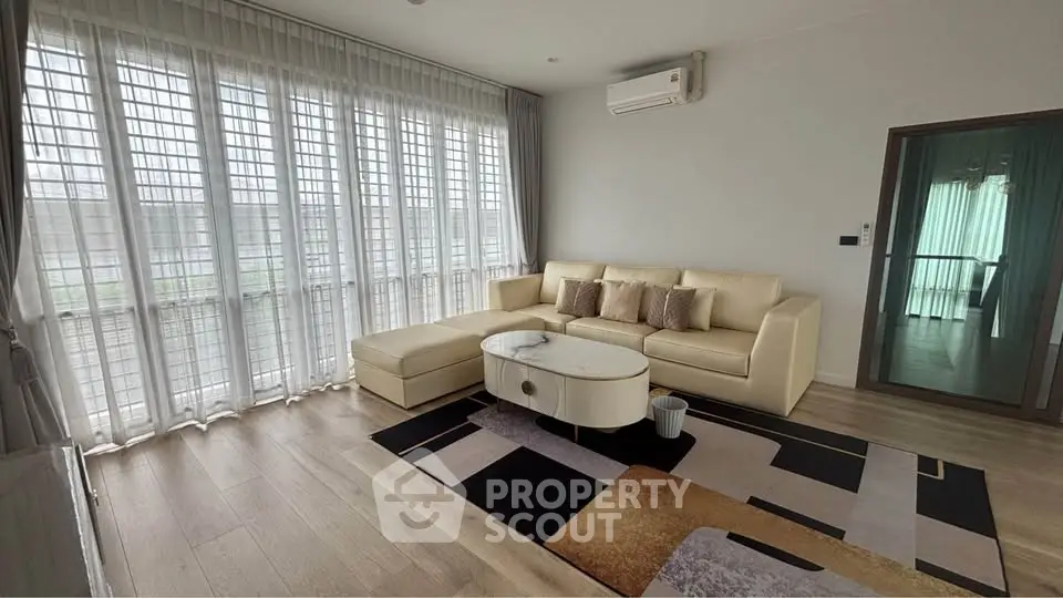 Spacious modern living room with large windows and elegant decor