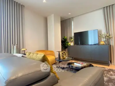 Modern living room with stylish furniture and large TV, perfect for relaxation and entertainment.