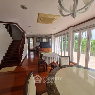 Spacious living room with elegant wooden flooring and large windows